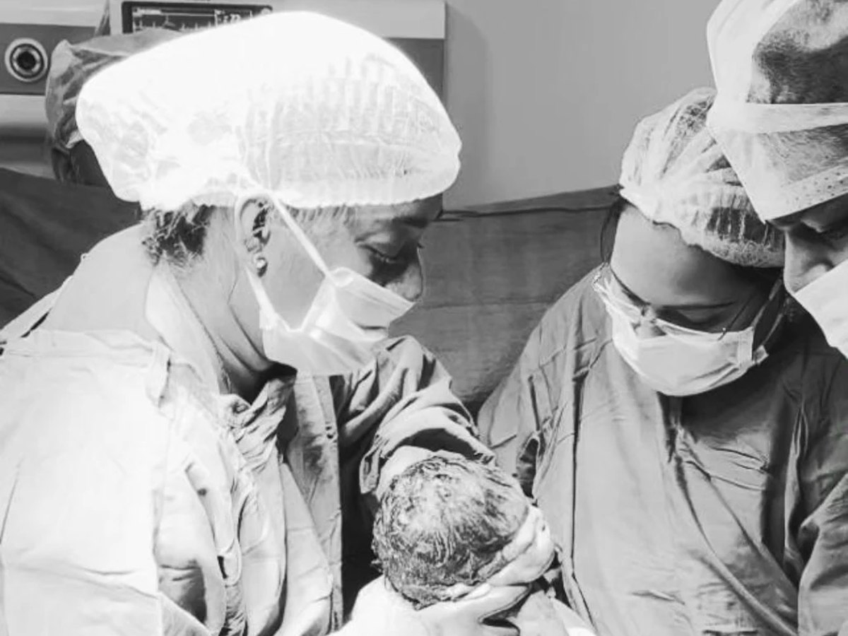 The delivery team receiving a newborn in theatre at Sharada's Urban Clinic
