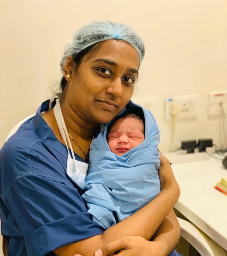A newborn held by a member of the clinic's team after delivery at Sharada's Urban Clinic, Madhura Nagar