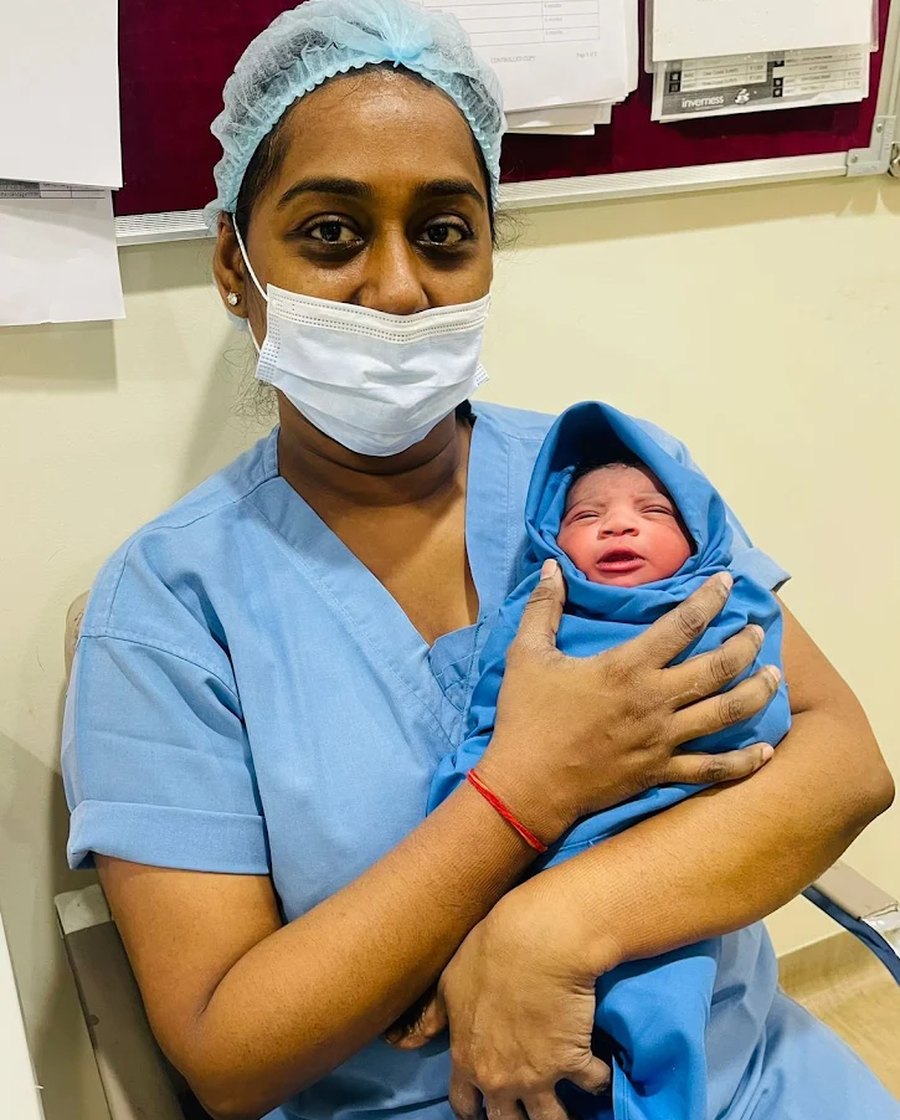 A newborn wrapped and held safely after delivery